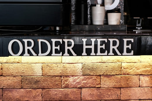 Schriftzug „Order Here“: Textagentur, Texter, Content-Manager für Ihre Branche gesucht? Hier qualitätsvolle Texte bestellen.